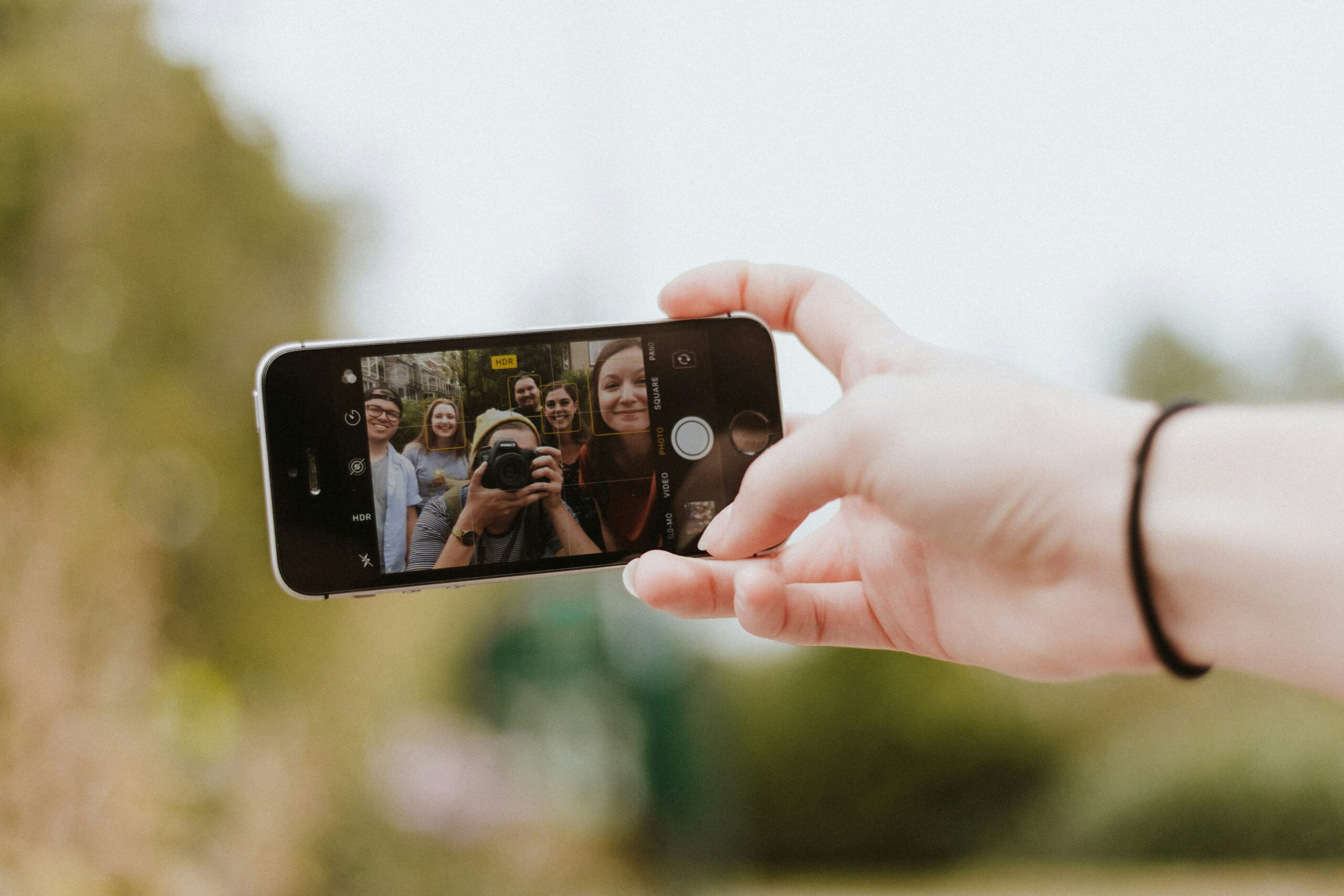 Videochat mit Freunden unterwegs verbunden. Smartphone mit Videochat, das in der Hand gehalten wird.